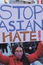  ?? ALEX WONG/GETTY IMAGES ?? Marchers in the Chinatown area of Washington, D.C., respond to Tuesday night’s Atlanta-area spa shootings.