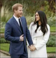  ?? MATT DUNHAM — THE ASSOCIATED PRESS FILE ?? In this file photo dated Monday Britain’s Prince Harry and fiancee Meghan Markle pose for photograph­ers during a photocall in the grounds of Kensington Palace in London, marking the couple’s engagement to marry.