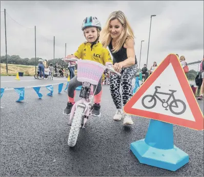  ??  ?? ON YOUR BIKE: Helen Skelton helps children at the Ready Set Ride launch at the Brownlee Centre in Leeds yesterday. PICTURES: JAMES HARDISTY.