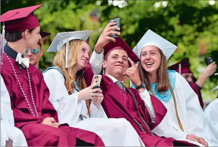  ?? TIM MARTIN/THE DAY ?? Graduates are asked to take out their cameras and photograph something they will remember for years to come, during Principal Kristen St. Germain’s address at the 62nd Wheeler High School commenceme­nt in North Stonington on Thursday. Go to www.theday.com for a list of graduates and more photos.