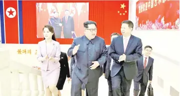  ?? — Reuters photo ?? Kim (centre) walks with Song and Ri to a banquet in honour of Song in this handout photo released by North Korea’s Korean Central News Agency (KCNA).