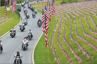  ?? Associated Press photo ?? Motorcycli­sts ride into Indiantown Gap National Cemetery in Annville, Pa., Saturday for a Memorial Day weekend program. While millions of Americans celebrate the long Memorial Day weekend as the unofficial start of summer, some veterans and loved ones...