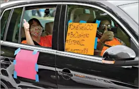  ??  ?? Motorists asking for an extension of the $600 in unemployme­nt benefits stemming from the coronaviru­s pandemic take part in a caravan protest in front of Sen. John Kennedy’s office on Wednesday at the Hale Boggs Federal Building in New Orleans. (Max Becherer/The Advocate via AP)