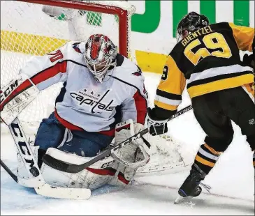  ?? GENE J. PUSKAR/THE ASSOCIATED PRESS ?? Capitals goaltender Braden Holtby stops a shot by the Penguins’ Jake Guentzel during the first period in Game 4 of an NHL second-round playoff series Thursday in Pittsburgh.