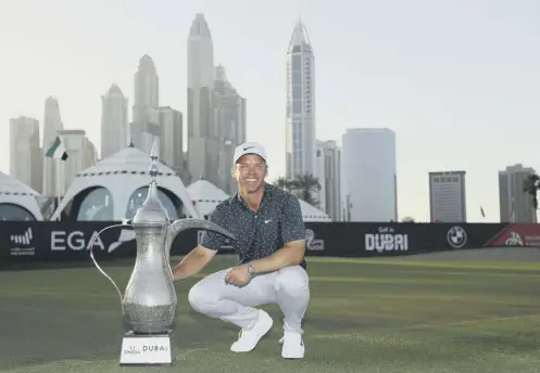  ??  ?? 0 Paul Casey with the iconic coffee pot trophy after his four-shot win in the Omega Dubai Desert Classic at Emirates Golf Club