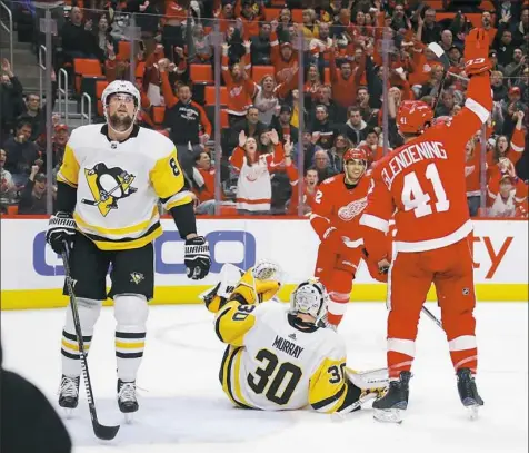  ?? Gregory Shamus/Getty Images ?? Detroit’s Luke Glendening, right, beats Matt Murray to help the Red Wings build a 3-1 lead in the second period Tuesday night.