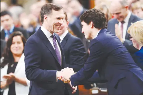  ?? CP PHOTO ?? Finance Minister Bill Morneau shakes hands with Prime Minister Justin Trudeau as he arrives in the House of Commons prior to tabling the federal budget in Ottawa.