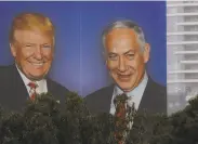  ?? Ariel Schalit / Associated Press ?? An election billboard in Tel Aviv shows President Trump and Prime Minister Benjamin Netanyahu.