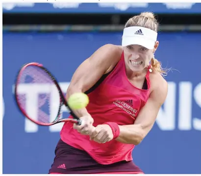  ??  ?? Angelique Kerber of Germany returns a shot to Naomi Osaka of Japan Monday during the first round match of the Pan Pacific Open tennis tournament in Tokyo. (AFP)