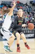  ??  ?? Terps freshman guard Sarah Myers, right, who had two key second-half assists, looks to pass while defended by guard Taryn McCutcheon.