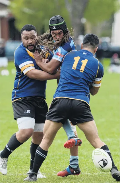  ?? PHOTO: LINDA ROBERTSON ?? Slips away . . . Otago Whalers Louis Tili (left) and Jong Hoon Lee knock the ball free from the hands of Northern Swords player Jesse Epiha during a crucial National Championsh­ip second division match at the North Ground on Saturday.