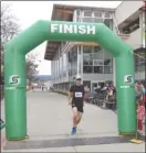  ?? Photo submitted ?? Jeff Vogt crosses the finish line at the 2015 OC half marathon.