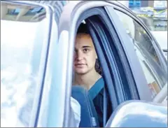  ?? GIOVANNI ISOLINO/AFP ?? German captain of humanitari­an ship Sea-Watch 3, Carola Rackete, looks on as she leaves in a car of the Italian Guardia di Finanza law enforcemen­t agency on Monday.