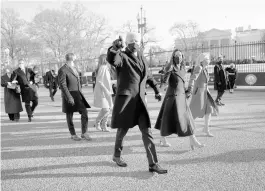  ?? DOUG MILLS/THE NEW YORK TIMES ?? President Joe Biden and first lady Jill Biden walk in front of the White House in Washington during the Presidenti­al Escort, part of Inaugurati­on Day ceremonies on Wednesday.