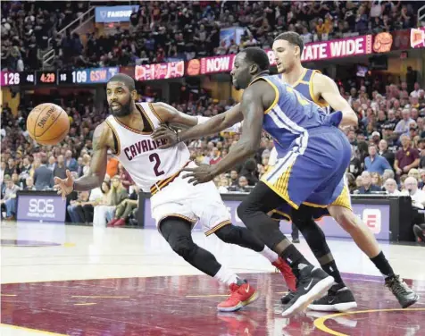  ?? — USA Today Sports ?? Cleveland Cavaliers guard Kyrie Irving (2) chases the ball with Golden State Warriors forward Draymond Green (23) and guard Klay Thompson (11) during the second half in game four of the 2017 NBA Finals at Quicken Loans Arena.