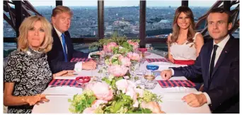  ??  ?? Haute cuisine: The Trumps and Macrons dining 377ft up the Eiffel Tower