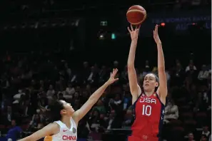  ?? The Associated Press ?? United States’ Breanna Stewart, right, shoots over China’s Zhang Ru during the gold medal game at the women’s Basketball World Cup Oct. 1 in Sydney, Australia. Brittney Griner is back in the United States after her arduous 10-month saga in Russia while nearly half of the players in the WNBA have opted to continue to compete abroad this winter.