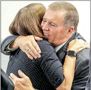  ?? Arkansas Democrat-Gazette/JOHN SYKES JR. ?? Maury Peterson, executive director of the Northwest Arkansas Children’s Shelter, embraces shelter finance director Rick Brazile after their applicatio­n was approved Tuesday in Little Rock.