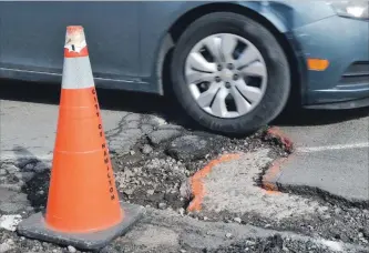  ?? JOHN RENNISON HAMILTON SPECTATOR FILE PHOTO ?? An old pothole on Burlington Street near Birch is seen in this file photo. Burlington Street East has the dubious honour of appearing in the annual top 10 Worst Roads more times than any other street.