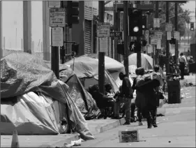  ?? AP Photo/Richard Vogel ?? In this 2019 file photo, tents housing homeless line a street in downtown Los Angeles.