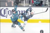  ?? D. ROSS CAMERON — THE ASSOCIATED PRESS ?? San Jose Sharks left wing Alexander Barabanov (94) and Winnipeg Jets left wing Nikolaj Ehlers (27) collide while pursuing the puck in the third period Saturday in San Jose.