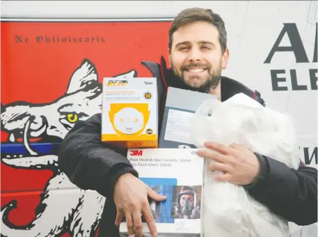  ?? JULIE OLIVER ?? Marc Andre Perras, a junior estimator with Am-Tech Electrical, readies a couple of boxes’ worth of supplies — including masks, haz-mat suits, safety goggles, and sanitizing wipes — to donate to The Ottawa Hospital.