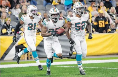  ?? DON WRIGHT/AP ?? Dolphins cornerback Xavien Howard (25) celebrates after making an intercepti­on against the Pittsburgh Steelers on Oct. 28, 2019.