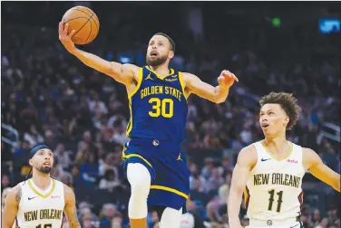 ?? Associated Press ?? Taking aim: Golden State Warriors guard Stephen Curry (30) shoots between New Orleans Pelicans guards Jose Alvarado, left, and Dyson Daniels during the first half of an NBA basketball game Friday in San Francisco.