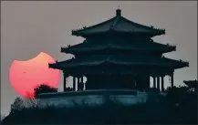  ?? BAI JIKAI / FOR CHINA DAILY ?? A partial solar eclipse is observed as the moon passes in front of the sun in Beijing on Sunday.