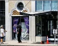  ?? Arkansas Democrat-Gazette/MITCHELL PE MASILUN ?? People take a look Sunday at the aftermath of the mass shooting at Power Ultra Lounge in downtown Little Rock.