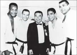  ?? San Jose State Athletics Archives ?? YOSH UCHIDA, center, coached the U.S. judo team in the 1964 Olympics: George Harris, left, James Bregman, Paul Maruyama and Ben Nighthorse Campbell.