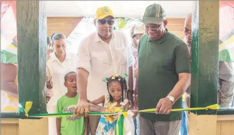  ??  ?? Minister of Natural Resources, Raphael Trotman and Minister of Finance, Winston Jordan cutting the ribbon to the newly refurbishe­d Kwakwani Workers’ Club. (DPI photo)