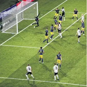  ?? PHOTO: GETTY IMAGES ?? Touch of class . . . Germany midfielder Toni Kroos (bottom left) curls the ball around the outstretch­ed arms of Sweden goalkeeper Robin Olsen to score his team’s winning goal in the 95th minute of the World Cup group F match in Sochi yesterday.