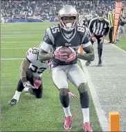  ?? AP FILE ?? New England Patriots wide receiver Kenbrell Thompkins holds the winning touchdown catch in front of New Orleans Saints cornerback Jabari Greer on Oct. 13, 2013. Thompkins is facing federal charges for alleged coronaviru­s relief fraud.