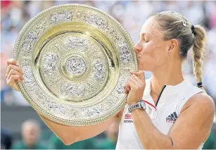  ??  ?? Angelique Kerber kisses the Wimbledon trophy after winning the women’s singles final against Serena Williams.