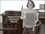  ??  ?? Nancy Crowe, president of the Catoosa County Historical Society, holds one of many books written by CCHS members. (Catoosa News photo/Tamara Wolk)