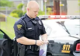  ??  ?? HUNTINGTON policeman Seth Craven gathers evidence at an overdose scene. A potent batch of heroin is thought to have led to the rash of overdoses.