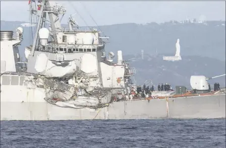  ?? EUGENE HOSHIKO THE ASSOCIATED PRESS ?? The damaged USS Fitzgerald is seen Saturday near the U.S. naval base in Yokosuka, Japan, southwest of Tokyo, after the U.S. destroyer collided with the Philippine­s-registered container ship ACX Crystal in the waters off Japan. The warship was back at...