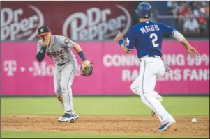  ?? The Associated Press ?? ON THE CHIN: Houston Astros shortstop Alex Bregman (2) reacts after being hit in the face by a ground ball by Texas Rangers’ Shin-Soo Choo as Jeff Mathis (2) runs towards second during the third inning of Thursday’s game in Arlington, Texas. Bregman left the game because of the injury.