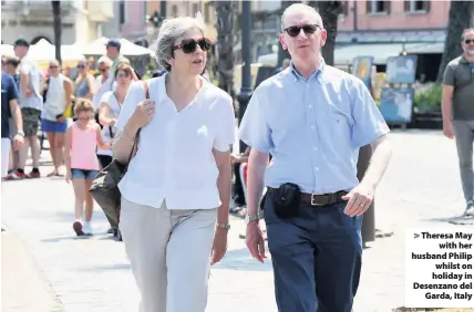  ??  ?? &gt; Theresa May with her husband Philip whilst on holiday in Desenzano del Garda, Italy