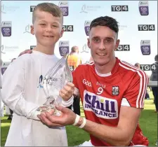  ??  ?? Tim O’Mahony of Cork is presented with his Bord Gáis Man of the Match award by Fionn Buckley, age 8, from Donoughmor­e
