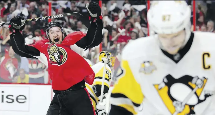  ?? WAYNE CUDDINGTON ?? Ottawa Senators right wing Mark Stone celebrates the Senators’ fourth goal of the first period as Pittsburgh Penguins captain Sidney Crosby, right, skates away during Game 3 of the Eastern Conference final on Wednesday in Ottawa. Crosby got...