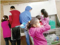  ?? — Reuters ?? Palestinia­ns fill bottles and containers with drinking water from public taps in Jabaliya refugee camp in the northern Gaza Strip.