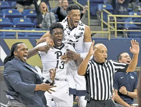  ?? Matt Freed/Post-Gazette photos ?? Excitement reigns on the Pitt bench after a 3-pointer by Jared Wilson-Frame late in the second half Wednesday night at Petersen Events Center.
