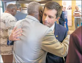  ??  ?? Democratic Presidenti­al candidate and South Bend, Indiana Mayor Pete Buttigieg hugs South Bend NAACP President Michael Patton.