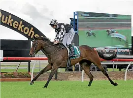  ?? TRISH DUNELL ?? Jonathan Ridell lets Darci La Bella glide across the line as she wins the Group II Dunstan Feeds Auckland Thoroughbr­ed Breeders Stakes (1400m) in Pukekohe on Saturday.