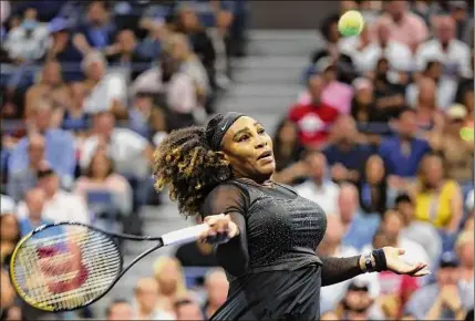  ?? Al Bello / Getty Images ?? Serena Williams returns a shot against Ajla Tomlijanov­ic during the third round at the U.S. Open on Friday. The match finished too late for this edition. For a complete story, go to http://timesunion.com/sports.