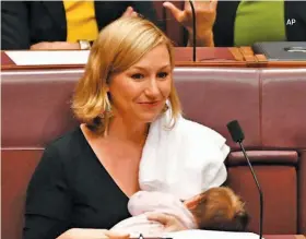  ??  ?? Larissa Waters, a former Australian senator, feeds her baby while the parliament is in session. She had to face backlash from online trolls.