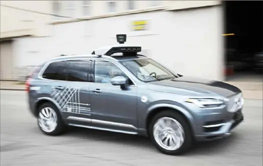  ?? Steve Mellon/Post-Gazette ?? A self-driving Uber vehicle in July on Smallman Street in the Strip District.