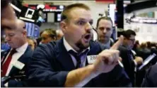  ?? RICHARD DREW — THE ASSOCIATED PRESS ?? Trader Michael Milano works on the floor of the New York Stock Exchange, Monday.